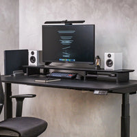 Omnidesk Arka desk riser black MDF on desk with monitor setup and storage space underneath