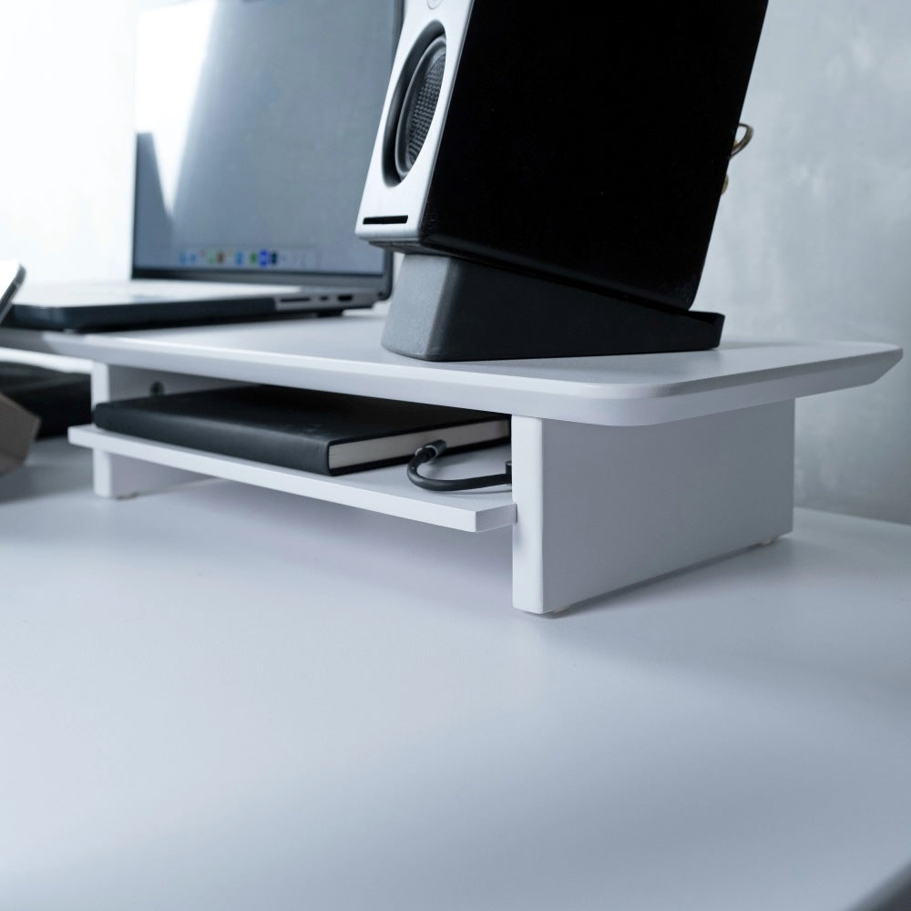 White monitor stand holding a laptop and computer monitor on a sit-stand desk